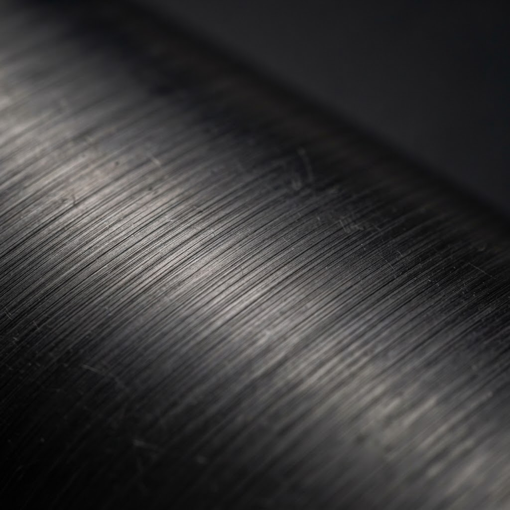 Macro texture of brushed stainless steel showing fine surface grain