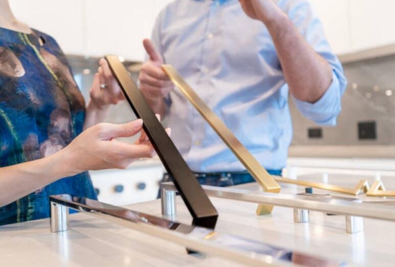 customers choosing door handles in a hardware store